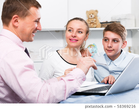 Mother and son signing documents Mother and son signing documents 58369216