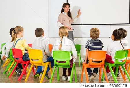 Teacher conducting lesson for school children Teacher conducting lesson for school children 58369456