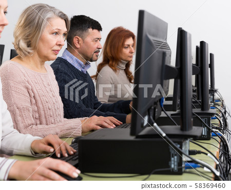 People of different ages learning to use computers People of different ages learning to use computers 58369460