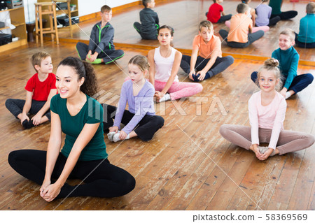 Positive children with trainer stretching 58369569