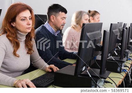 Elderly people attending pc class Elderly people attending pc class 58369571