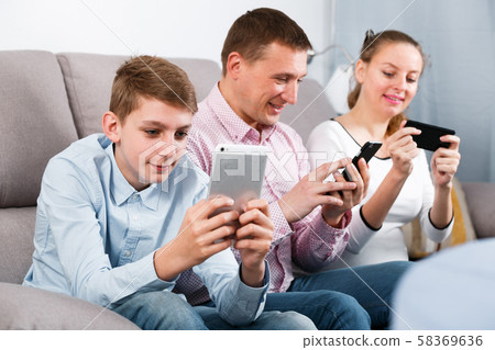 Parents and son using phones Parents and son using phones 58369636
