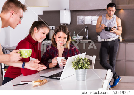 People discussing in hostel kitchen People discussing in hostel kitchen 58369765