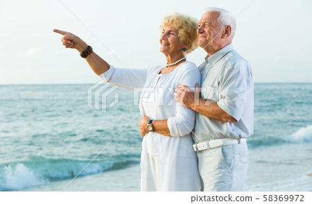 male and female pointing finger at the ocean male and female pointing finger at the ocean 58369972