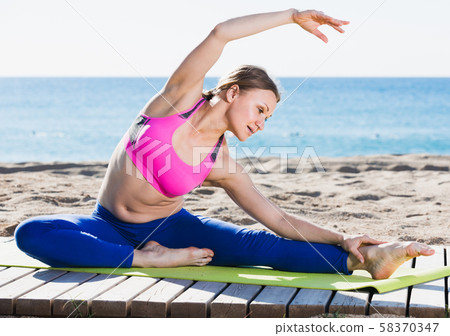 Female is practicing yoga Female is practicing yoga 58370347