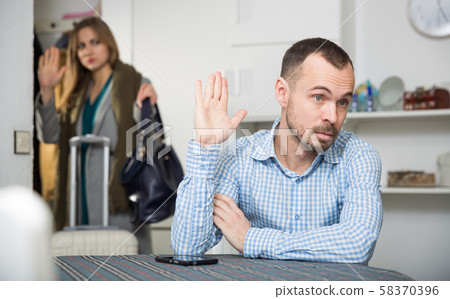 Annoyed man gesturing enough to girlfriend leaving him Annoyed man gesturing enough to girlfriend leaving him 58370396