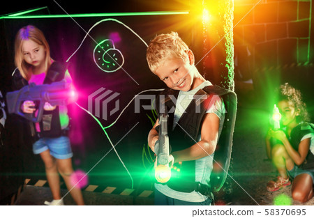 Preteen boy with laser pistol playing on labyrinth Preteen boy with laser pistol playing on labyrinth 58370695