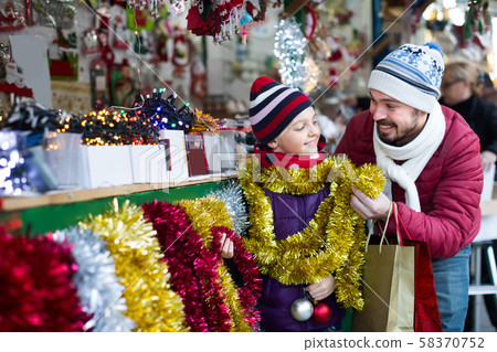Little girl with dad buying decorations for Xmas 58370752