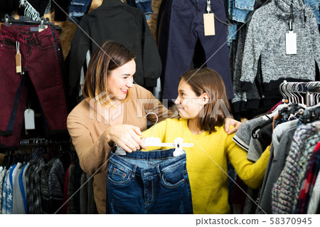 Mother and daughter deciding on new jeans Mother and daughter deciding on new jeans 58370945