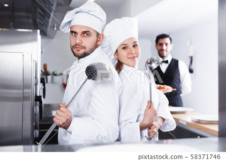 Chefs in fish restaurant kitchen Chefs in fish restaurant kitchen 58371746