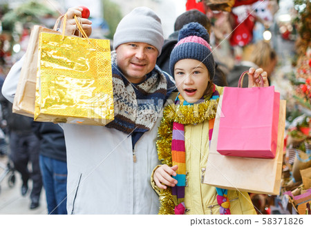 Happy family after shopping on Christmas market Happy family after shopping on Christmas market 58371826