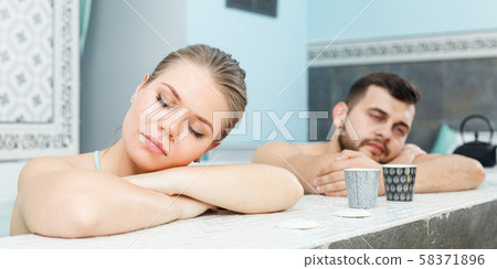 Couple relaxing in jacuzzi Couple relaxing in jacuzzi 58371896