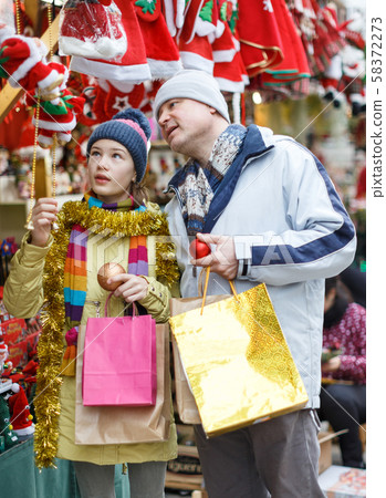 Father with daughter selecting Christmas decoration 58372273