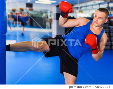Potrait of man boxer who is training in gym. 58372274