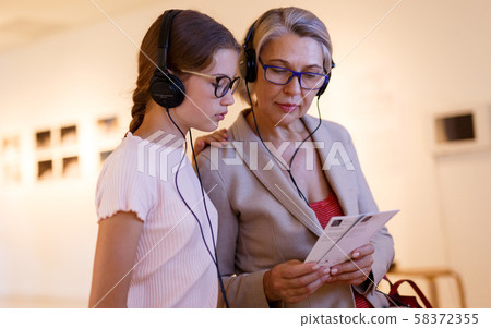 People using audio guide in museum People using audio guide in museum 58372355