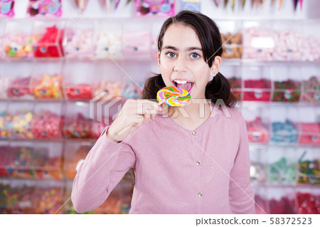 Emotional schoolgirl with lollipop 58372523