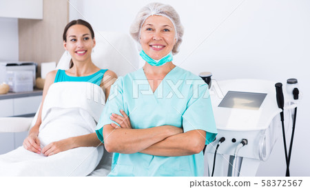 Female beautician in clinic of esthetic medicine Female beautician in clinic of esthetic medicine 58372567