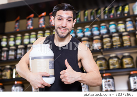 Adult sport man holding thumb up in store Adult sport man holding thumb up in store 58372663
