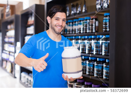 sportsman holding thumb up and sport nutrition sportsman holding thumb up and sport nutrition 58372699