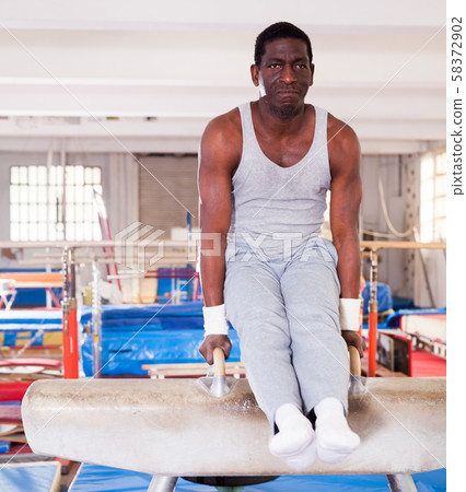 Man training on pommel horse Man training on pommel horse 58372902