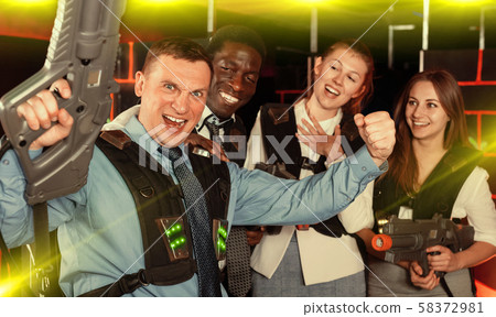 males and females in business suits posing at laser tag room 58372981