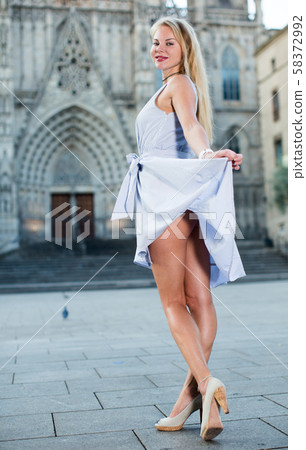 smiling woman holding dress in the hand smiling woman holding dress in the hand 58372992
