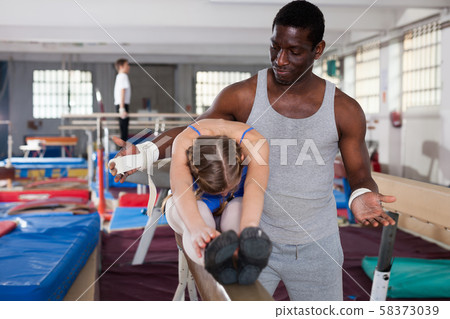 Nice African male coach helping teenage girl Nice African male coach helping teenage girl 58373039