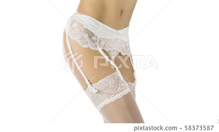 Female hips in white bridal garter belt, fishnet stockings and lace panties. Close up, isolated on 58373587
