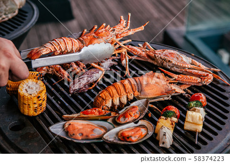 Lobster and mix seafood barbecue cokking on grill 58374223