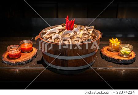 Fresh whole marine Fine de claire oysters in oak 58374224