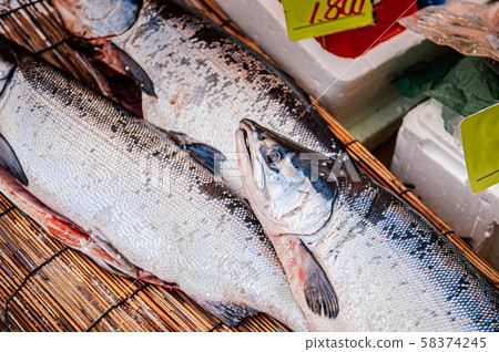 Whole fresh raw salmons on bamboo straw mat. Whole fresh raw salmons on bamboo straw mat. 58374245