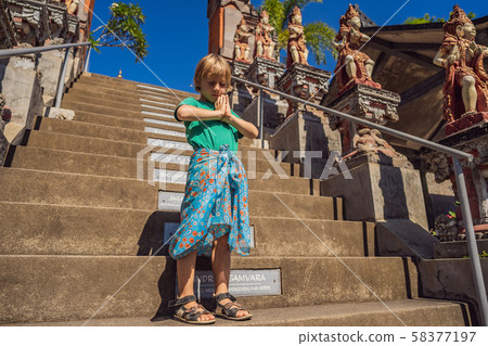 Young boy tourist in budhist temple Brahma Vihara Arama Banjar Bali, Indonesia Young boy tourist in budhist temple Brahma Vihara Arama Banjar Bali, Indonesia 58377197