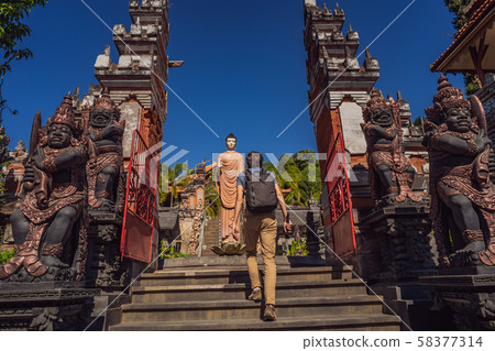 Young man tourist in budhist temple Brahma Vihara Arama Banjar Bali, Indonesia Young man tourist in budhist temple Brahma Vihara Arama Banjar Bali, Indonesia 58377314