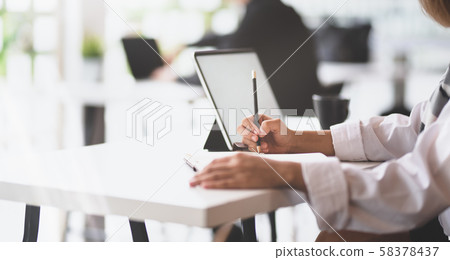 Smart female startup member writing her Smart female startup member writing her 58378437