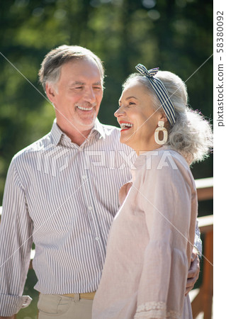 Stylish beautiful wife laughing while talking with husband Stylish beautiful wife laughing while talking with husband 58380092