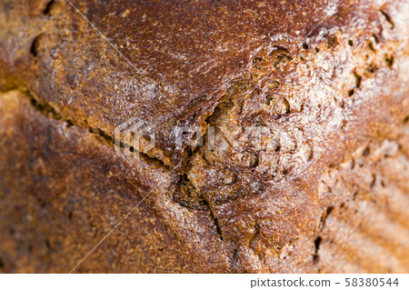 a whole loaf of black rye bread 58380544