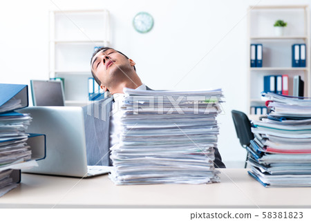Businessman with heavy paperwork workload 58381823