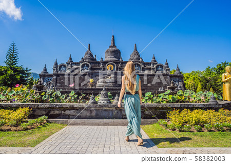 Young woman tourist in budhist temple Brahma Vihara Arama Banjar Bali, Indonesia Young woman tourist in budhist temple Brahma Vihara Arama Banjar Bali, Indonesia 58382003