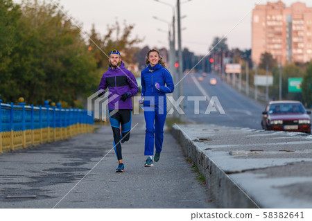 Man and woman running in park in the morning 58382641