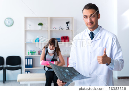 Young woman visiting male doctor traumatologist 58382816