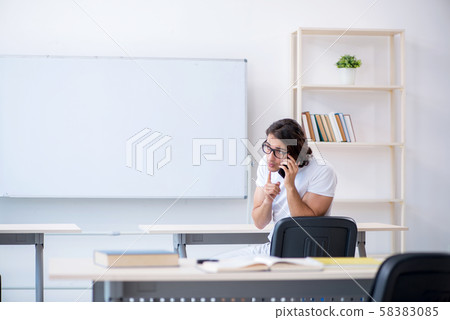 Young male student in front of whiteboard Young male student in front of whiteboard 58383085