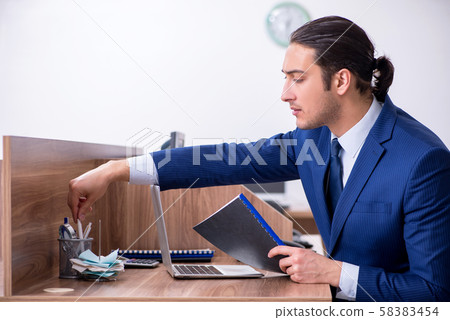 Young handsome businessman working in the office 58383454