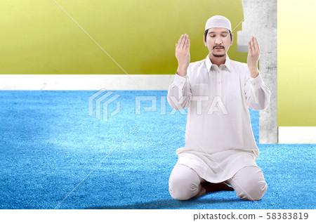 Asian Muslim man sitting in pray position Asian Muslim man sitting in pray position 58383819