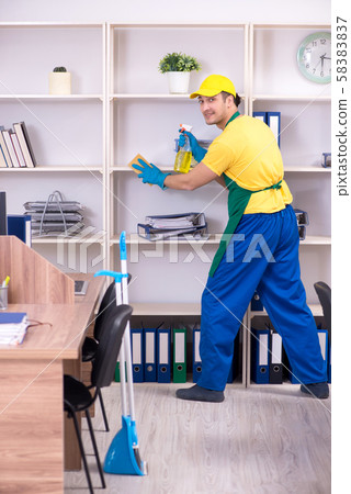 Young male contractor cleaning the office Young male contractor cleaning the office 58383837