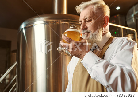 Brewery expert tasting cold large beer with foam. Brewery expert tasting cold large beer with foam. 58383928