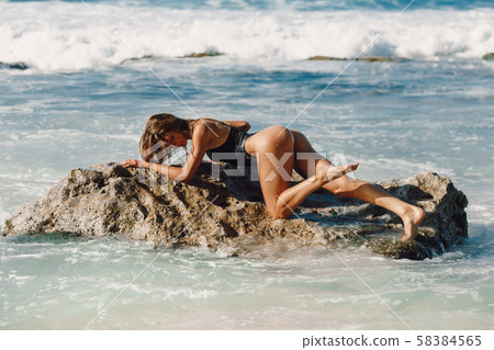 Attractive young woman, model in bikini at tropical beach. 58384565
