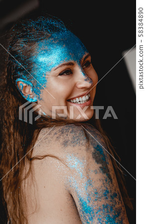 Portrait of beautiful woman with sparkles on her face. Girl with art make up 58384890