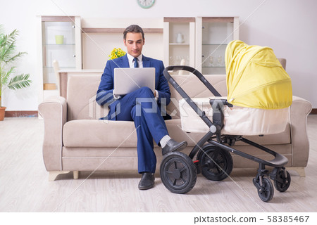 Young businessman looking after baby 58385467