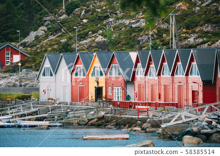Alnes, Godoya, Norway. Red And Yellow Colorful Wooden Docks In Summer Day. Godoy Island Near Alesund 58385514