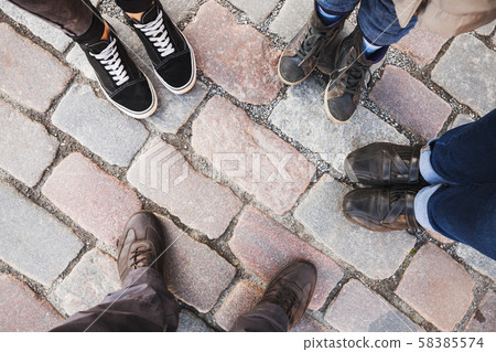 Feet of a family standing together Feet of a family standing together 58385574